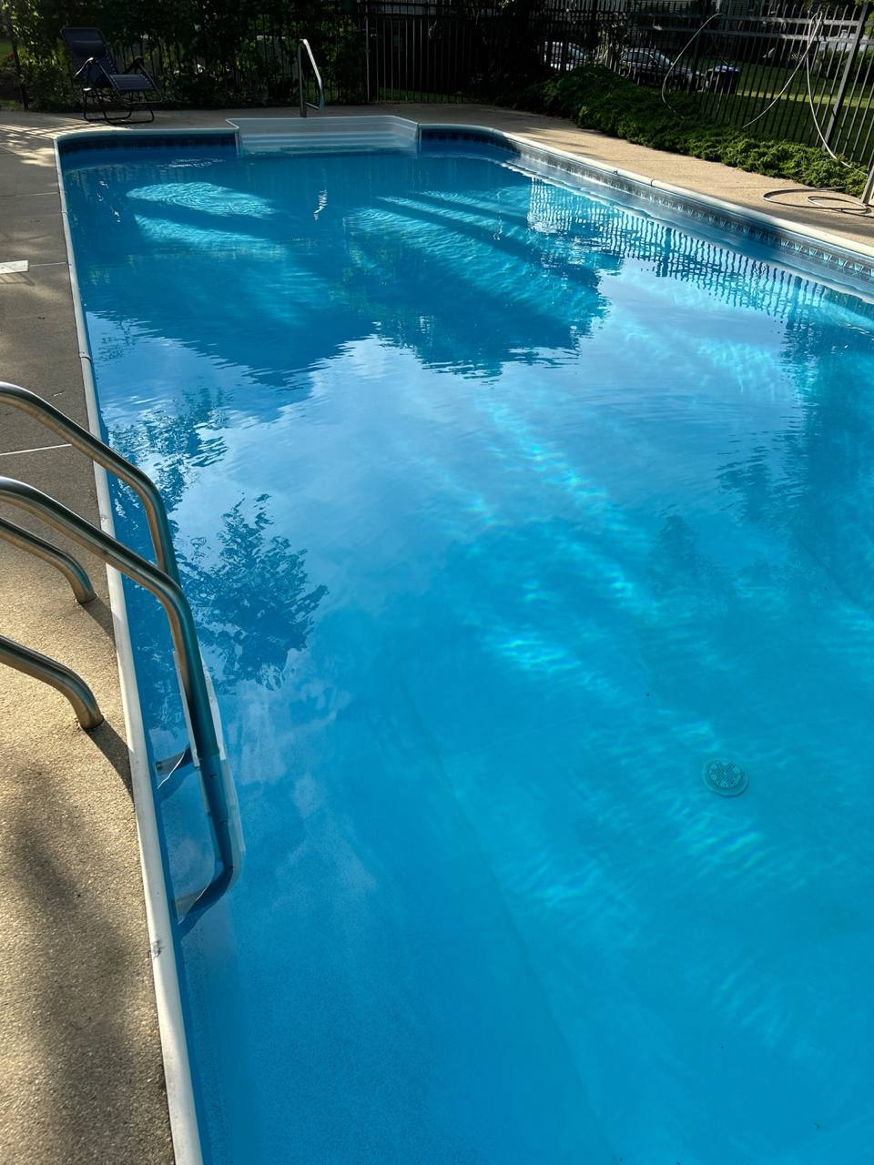 Clear blue backyard pool ready for summer